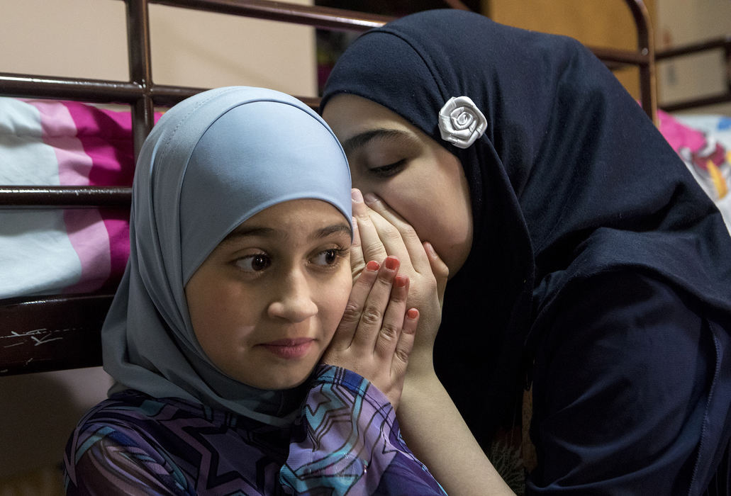 Second Place, Ohio Understanding Award - Jessica Phelps / Newark Advocate, "First Generation"Dima Al Haek whispers a secret into her younger sister, Maryam's ear at her birthday party, November 25, 2017. 