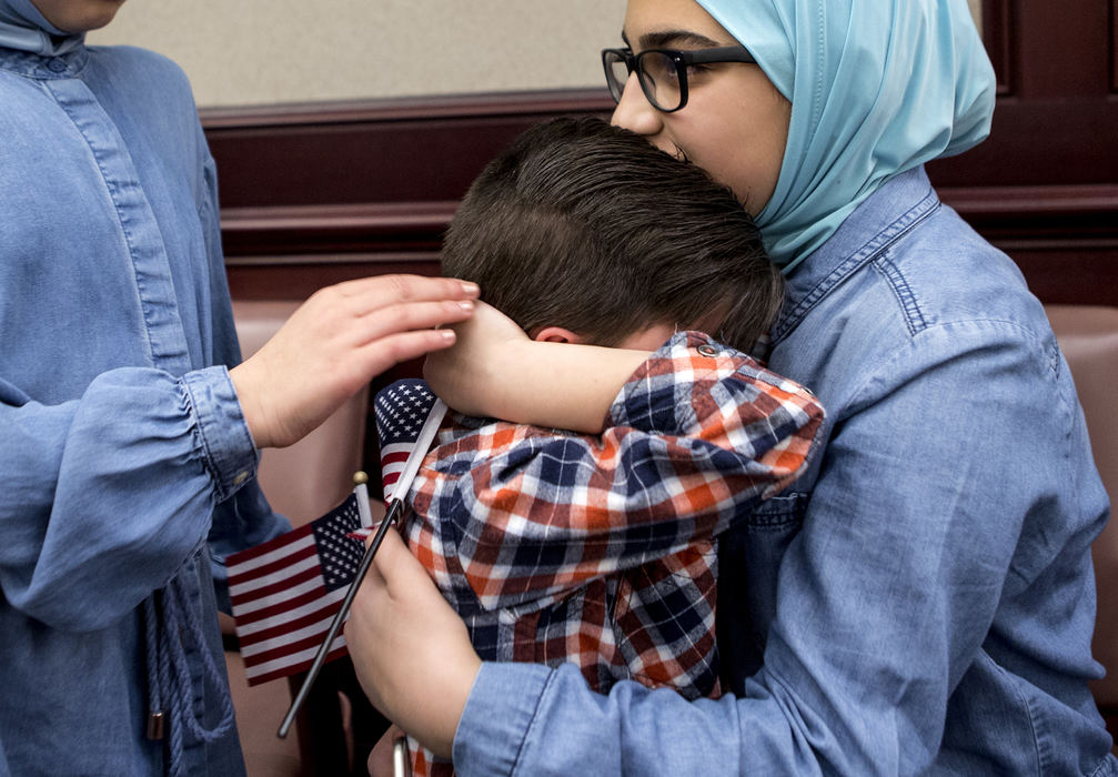 Second Place, Ohio Understanding Award - Jessica Phelps / Newark Advocate, "First Generation"Dima Al Haek (left) hugs her little brother Mousa, while he sister, Maryam gently pats his hand. Mousa had bumped his head in the courtroom just after his mom, Dunya, officially received her citizenship, November 14, 2018. The family has been living in the United States since 2011, after fleeing from the war in Iraq.