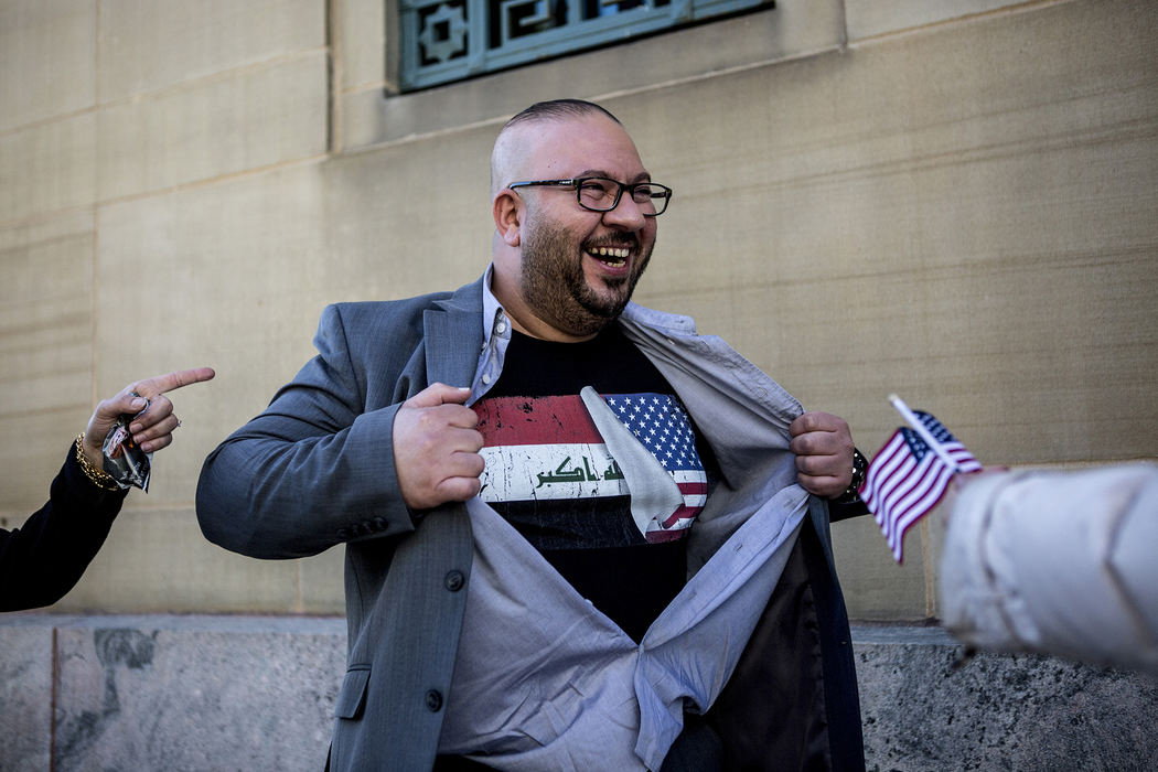 Second Place, Ohio Understanding Award - Jessica Phelps / Newark Advocate, "First Generation"Ahmed Al Haek opens his shirt "Superman" style to reveal a T-shirt with both the Iraqi and American flags while on the steps of the courthouse. Ahmed received his citizenship after going through the naturalization ceremony October 23, 1018. Ahmed brought his family to the US in 2011 on a green card after serving as a translator with the military in Iraq. 