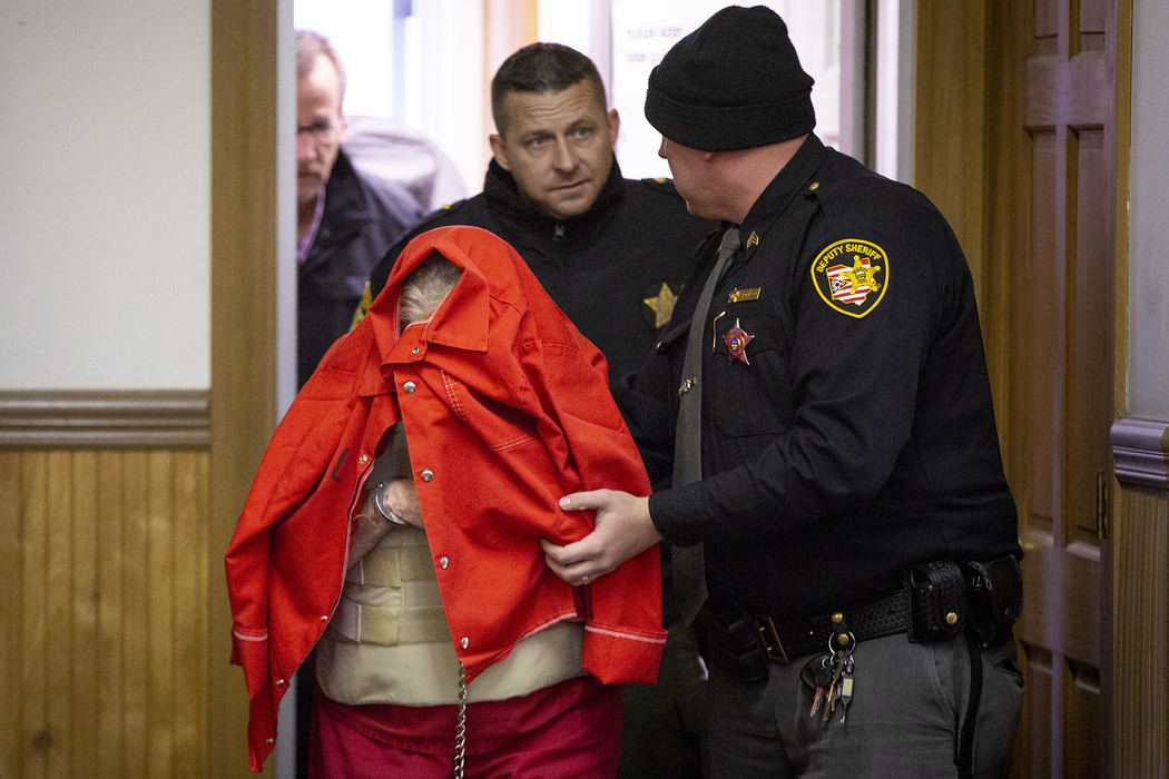 First Place, Photographer of the Year - Large Market - Meg Vogel / The Cincinnati EnquirerFredericka Wagner, 76, of Lucasville, covers her face as she walks into the Pike County Courthouse for her arraignment Thursday, November 15, 2018. Wagner along with Rita Newcomb, 65, of South Webster, are accused of perjury and obstructing justice for allegedly misleading investigators; Newcomb also is charged with forging custody documents to cover up the crimes. The women are mothers of Angela Wagner and George "Billy" Wagner and grandmothers of the Wagners' two sons, George Wagner IV and Edward "Jake" Wagner, who are facing murder charges. The killings took place in 2016 at different scenes, all around the same time with 32 bullets fired into the eight victims. It would spawn the largest homicide investigation in Ohio history.  