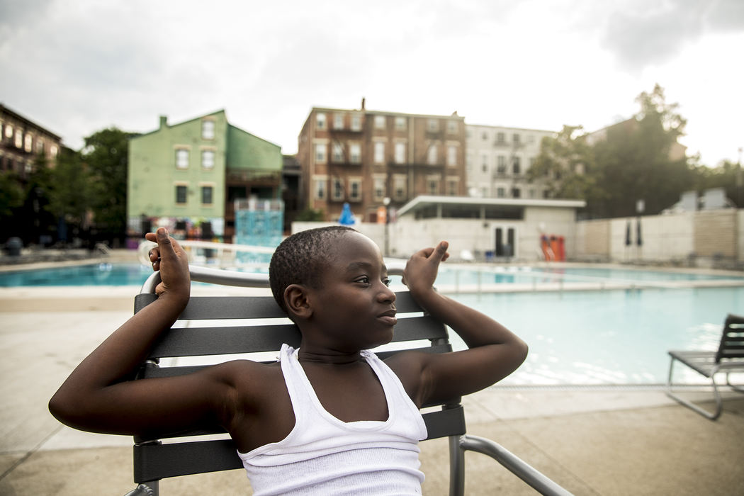 First Place, Photographer of the Year - Large Market - Meg Vogel / The Cincinnati EnquirerMiron Siler sits by the pool for his swim team's end of the season party at Ziegler Pool in Over-the-Rhine, August 1, 2018.