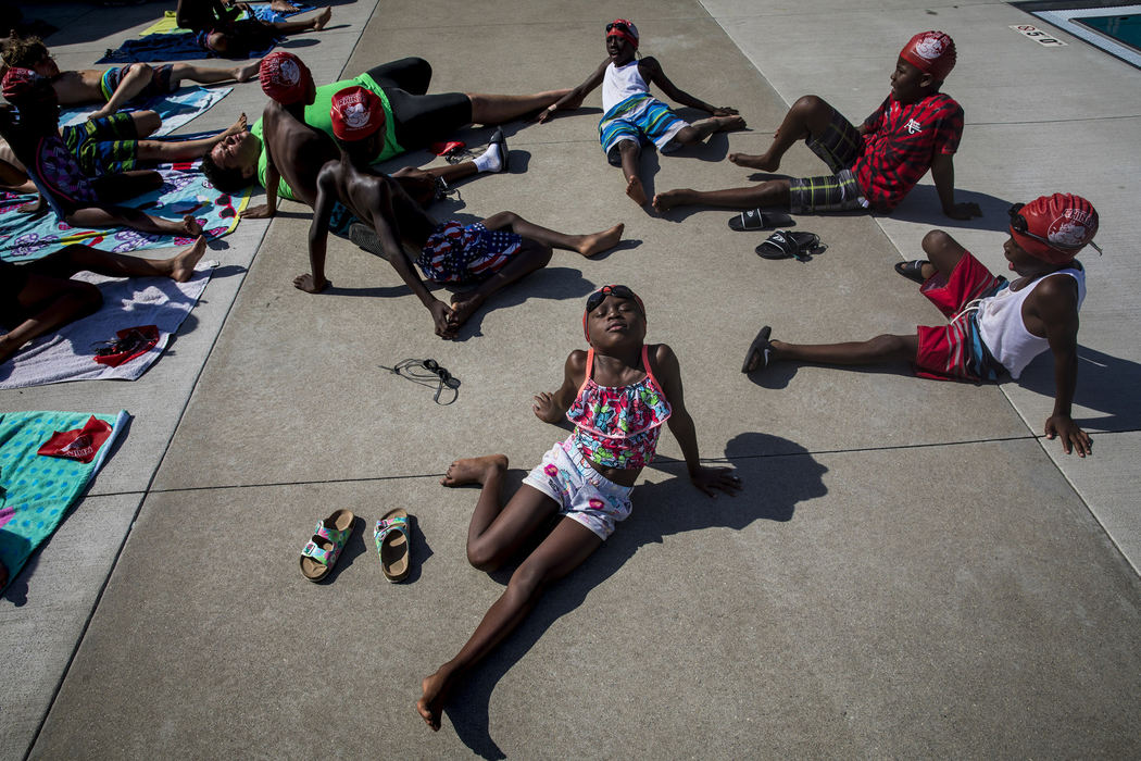 First Place, Photographer of the Year - Large Market - Meg Vogel / The Cincinnati EnquirerKamilah Johnson stretches during warmups before a practice. The group wears swim caps featuring a logo design from Cincy Shirts, a company located just blocks away from Ziegler Park. 