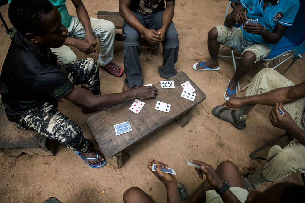 First Place, Photographer of the Year - Large Market - Meg Vogel / The Cincinnati EnquirerA group of trackers play cards at the end of the day. Goualougo Triangle trackers and researchers wake up every morning at four. They leave camp at 6 a.m. and follow the great apes for ten hours. Their knowledge of the forest is invaluable to the research. The work is consistent, well-payed and rewarding.