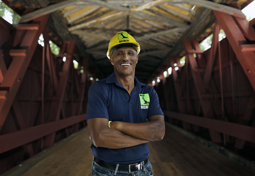 Second Place, Photographer of the Year - Large Market - Kyle Robertson / The Columbus DispatchRetta Tegegne of Bezalel Construction worked on the roof of a covered bridge in Upper Sandusky on June 21, 2018.  Tegegne is from Ethiopia and started Bezalel Construction in 2009. 