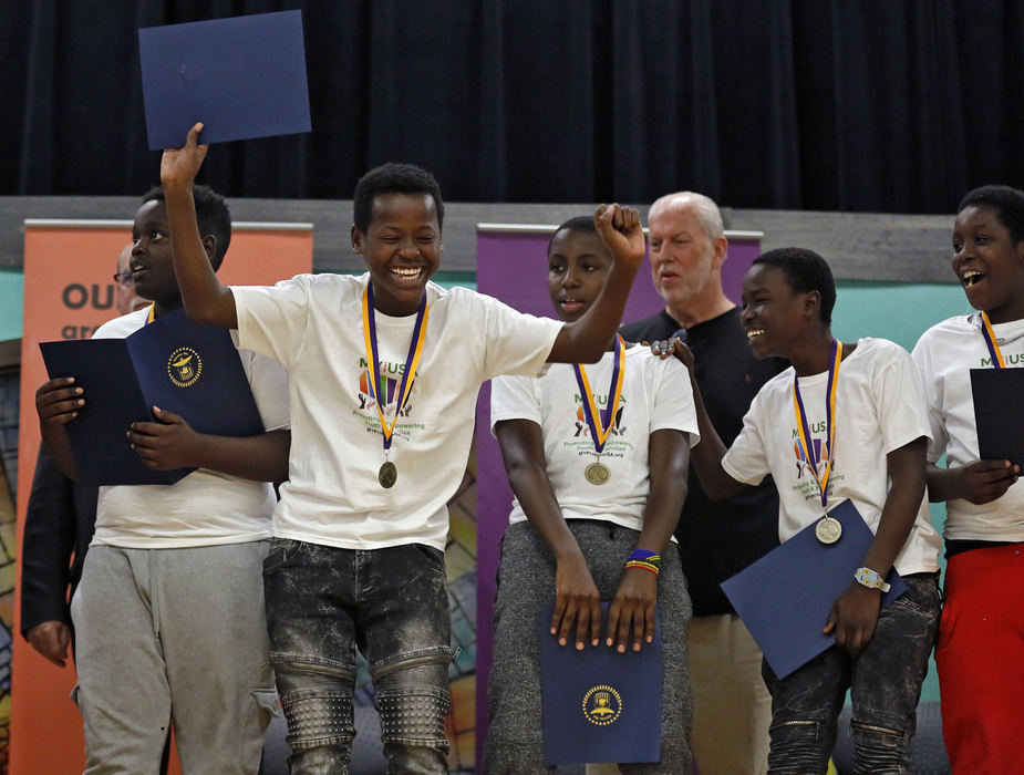 Second Place, Photographer of the Year - Large Market - Kyle Robertson / The Columbus DispatchAmbar Abdiwahab of the U15 Hilltop Tigers dances on the stage after receiving medallions and certificates by the Columbus City Council after a successful soccer season at the Westgate Community Recreation Center in Columbus on November 14, 2018. About 70 kids from Wedgewood Village, mostly comprised of Somali immigrant families, played in 4 different teams in the Mid Ohio Select Soccer League this season.