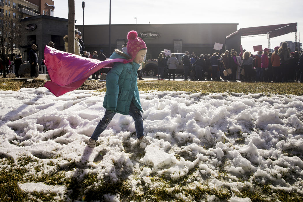 First Place, Photographer of the Year - Large Market - Meg Vogel / The Cincinnati EnquirerDahlia Dunkin, 4, of North College Hill, plays in the snow while speakers address the crowd of thousands at the Cincinnati Women's March, January 20, 2018 in downtown Cincinnati.
