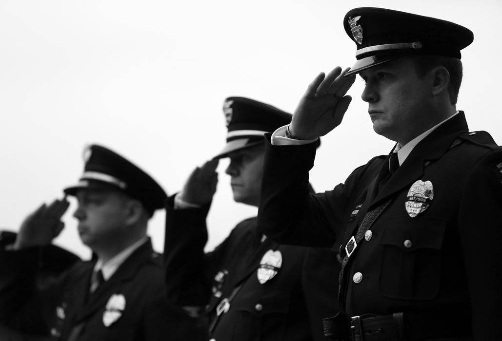 Second Place, Photographer of the Year - Large Market - Kyle Robertson / The Columbus DispatchWesterville Police line up to escort the casket of Westerville Police officers Joering and Morelli into St. Paul Catholic Church for the funeral services in Westerville on February 16, 2018. 