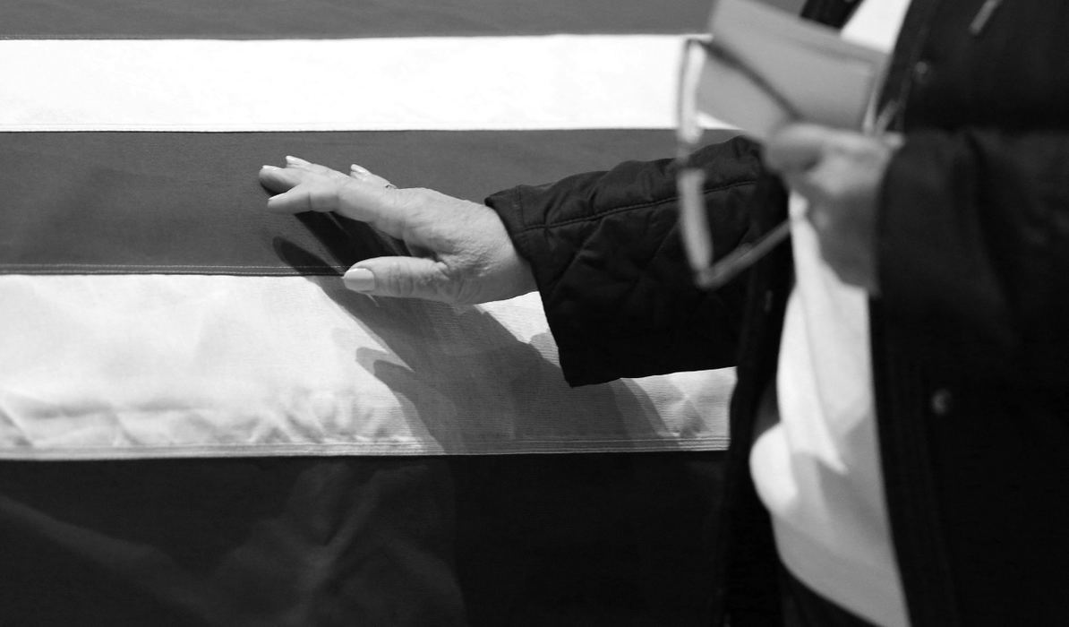 Second Place, Photographer of the Year - Large Market - Kyle Robertson / The Columbus DispatchA mourner touches the casket of officer Morelli at St. Paul Catholic Church during the public viewing of Westerville Police officers Joering and Morelli in Westerville on February 16, 2018. 