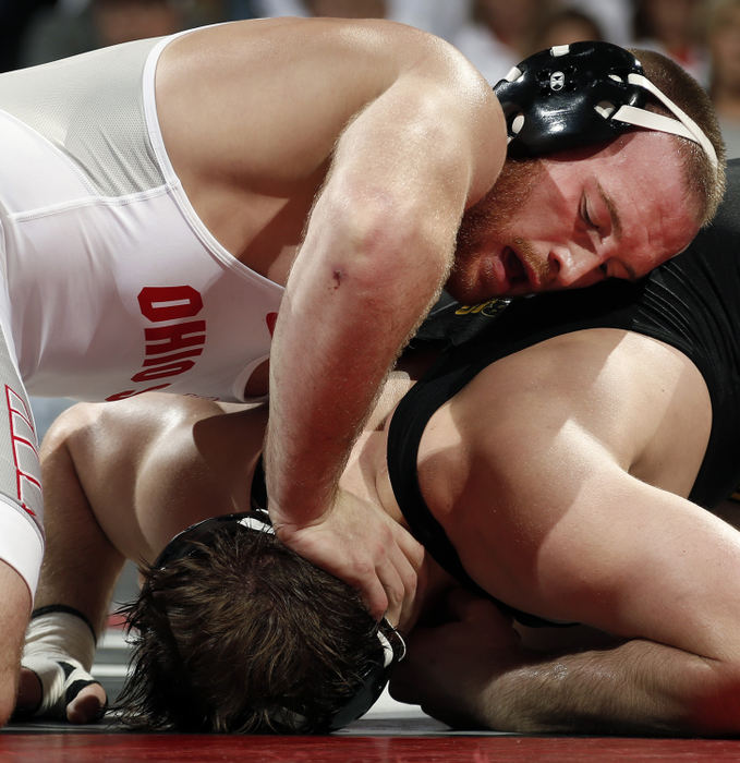 Second Place, Photographer of the Year - Large Market - Kyle Robertson / The Columbus DispatchOhio State's Kyle Snyder wrestles Iowa's Steven Holloway during the 285 match at Value City Arena in Columbus on January 21, 2018. Snyder won TF 24-9.  After the match Kyle goes to Russia for team USA and wrestles in the Ivan Yarygin Grand Prix .  Snyder becomes  the first U.S. man to win two Ivan Yarygin Grand Prix gold medals with a victory at 97 kilograms/213 pounds at the open tournament Sunday in Krasnoyarsk, Russia.