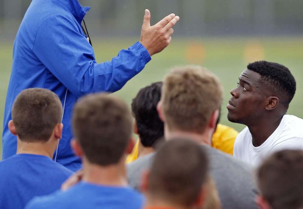 Second Place, Photographer of the Year - Large Market - Kyle Robertson / The Columbus DispatchOlentangy Orange's Zach Harrison listens to his head football coach Zebb Schroeder speaks to the his team during the first day of fall practice on July 30, 2018. 
