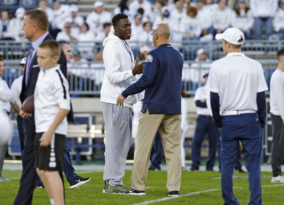 Second Place, Photographer of the Year - Large Market - Kyle Robertson / The Columbus DispatchOlentangy Orange's Zach Harrison meets Penn State head coach James Franklin at midfield before Penn State game against Ohio State game at Beaver Stadium on September 29, 2018.  Zach was the only recruit who got to meet Franklin on the field before the game. 