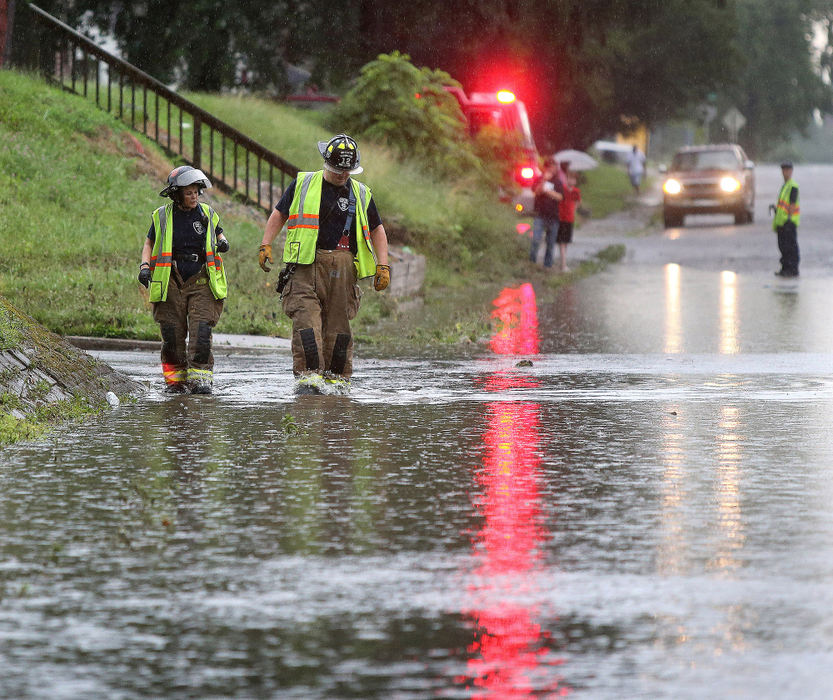 Award of Excellence, Photographer of the Year - Small Market - Scott Heckel / The Canton RepositoryCanton firefighter/paramedics Debbie Dawson (left) and Jimmy Mills walk through water on Spring Avenue NE and 14th Street NE after a storm swept through Canton causing flash flooding Thursday, July 5, 2018. 