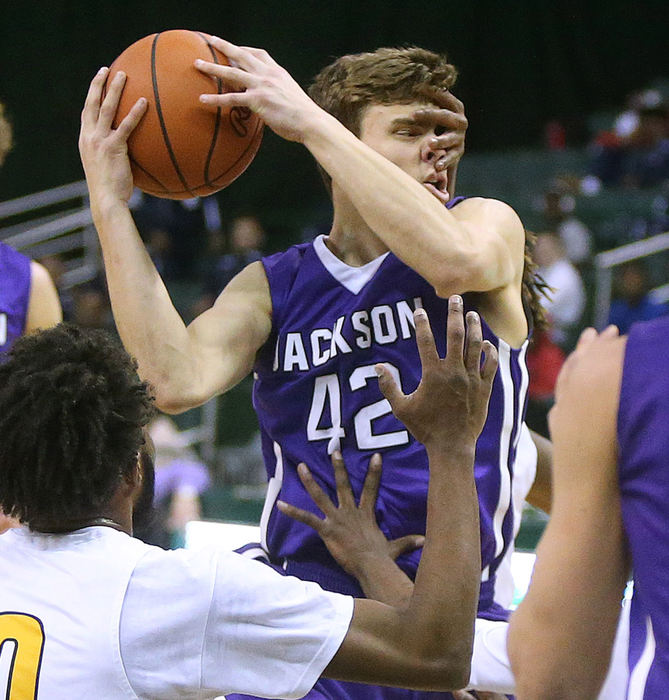 Award of Excellence, Photographer of the Year - Small Market - Scott Heckel / The Canton RepositoryJackson’s Jake Ehmann takes a hand to the face while driving through the lane during the second quarter of their D1 regional semifinal game against Copley at the Wolstein Center in Cleveland on Wednesday, March 14, 2018. 