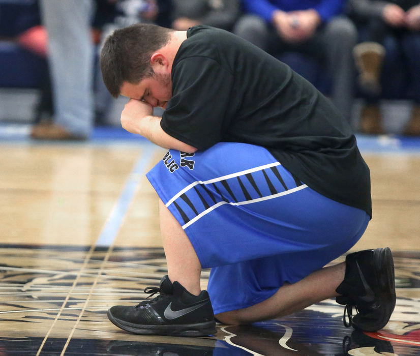 Award of Excellence, Photographer of the Year - Small Market - Scott Heckel / The Canton RepositoryRoyal Knights' Nick Doyle takes a knee and prays at center court before their Stark Public Special Olympics game against Medina DD at Louisville on Thursday, Jan. 11, 2018.