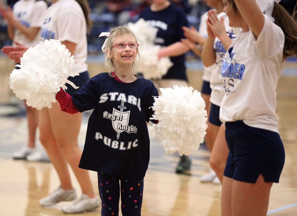 Award of Excellence, Photographer of the Year - Small Market - Scott Heckel / The Canton RepositoryEmily Hill cheers with Louisville cheerleader Caroline Gatta  during a Stark Public Special Olympics game between the Royal Knights and Medina DD at Louisville on Thursday, Jan. 11, 2018. 