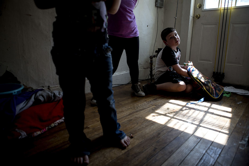 First Place, Photographer of the Year - Small Market - Jessica Phelps / Newark AdvocateLandon Crawford unpacks his backpack in the entryway of his home April 26, 2018. Landon, his five siblings and parents live in a crowded unsafe home in Newark, Ohio. Finding safe affordable housing in the city has become an issue for many families in the area. 