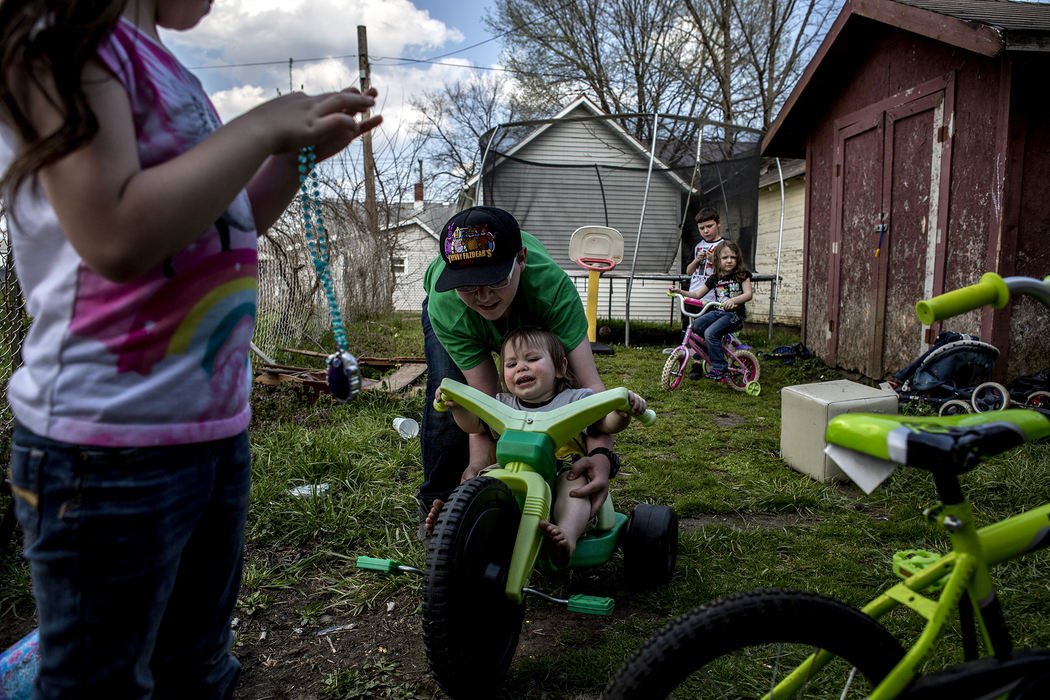 First Place, Photographer of the Year - Small Market - Jessica Phelps / Newark AdvocateRaquel, Jay, Tristen, Landon and Sorai Crawford, play on their bikes in their backyard, April 26, 2018, in Newark, Ohio. Melissa, their mom is always watching them outside because the yard is not safe for the children to play in alone, and there is a whole in the fence the younger children could escape through. Her landlord has been notified multiple times but has yet to fix the problem. 