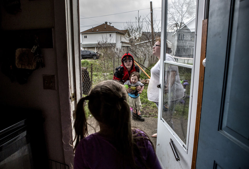 First Place, Photographer of the Year - Small Market - Jessica Phelps / Newark AdvocateMelissa Crawford hurries her children inside as rain begins to fall on April 26, 2018, in Newark, Ohio. Melissa, is always watching them outside because the yard is not safe for the children to play in alone, and there is a whole in the fence the younger children could escape through. Her landlord has been notified multiple times but has yet to fix the problem. 