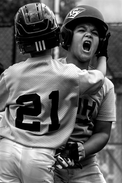 First Place, Photographer of the Year - Small Market - Jessica Phelps / Newark AdvocateJaiden Dansby is embraced by teammate Jackson Broyles after scoring the first run the the game for LMH against Newark Optometry on June 16, 2018. LMH won the quarterfinal game 10-2, and proceeded to the semifinal game the following weekend where they lost to Dor Mar NNL in the variety league. 