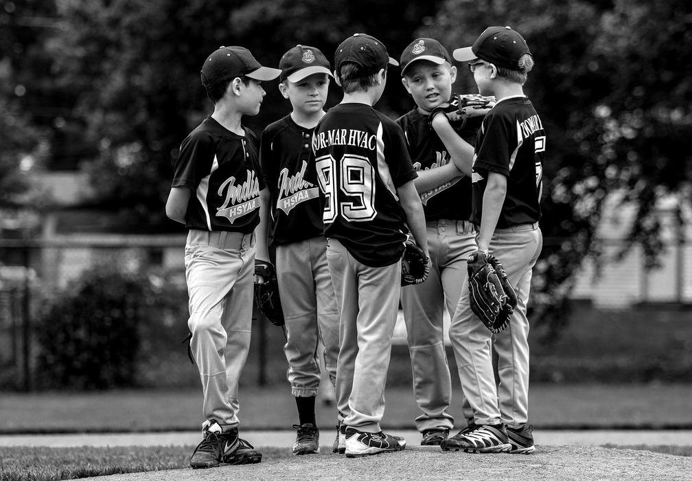 First Place, Photographer of the Year - Small Market - Jessica Phelps / Newark AdvocatePlayers from the Dor-Mar HSYAA farm team gather on the pitchers mound during a time-out in the first round of tournament games during the 74th annual Shrine Tournament held at Mound City Ball Park in June 2, 2018. 