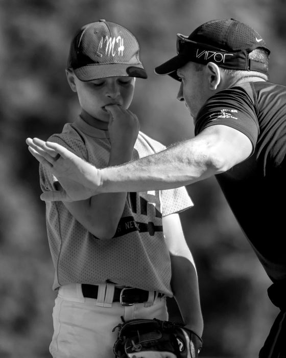 First Place, Photographer of the Year - Small Market - Jessica Phelps / Newark AdvocateBrayden Koby of the LMH farm team gets a pep talk from his coach and father, Brian Koby, during the 5th inning of the consolation game against Newark Optometry June 29, 2018. LMH won the consolation game, placing them 3rd in the 74th annual Shrine Tournament farm division. 
