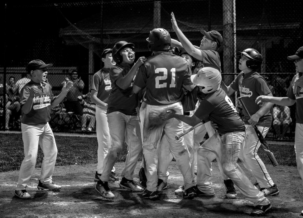 First Place, Photographer of the Year - Small Market - Jessica Phelps / Newark AdvocateMattlingly Landscape players celebrate Hayden Woodward and his home-run hit as he rounds out to home plate in the championship game June 28, 2018. Woodword's homer wasn't enough to give Mattingly Landscape the Shrine Championship Title. They lost the game to Dor-Mar. 