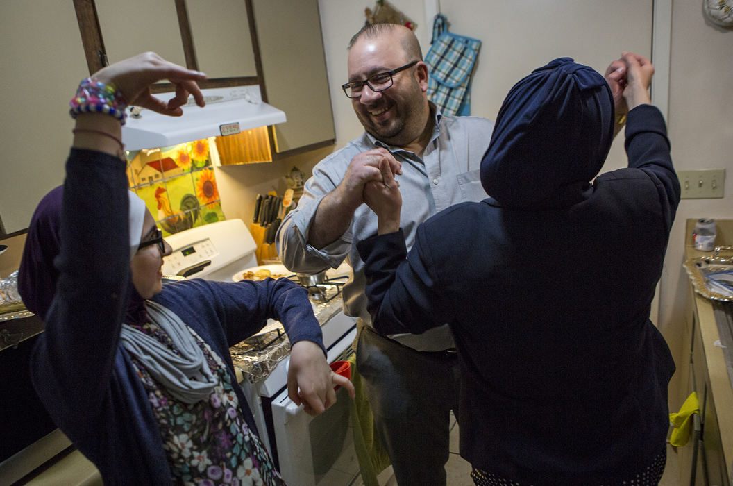 First Place, Photographer of the Year - Small Market - Jessica Phelps / Newark AdvocateAhmed Al Haek dances in the kitchen with his wife, Dunya and oldest daughter Dima at his sisters engagement party, March 25, 2018. Ahmed and Dunya are making sure their children experience the best of American culture while ensuring they hold onto their Iraqi roots. 