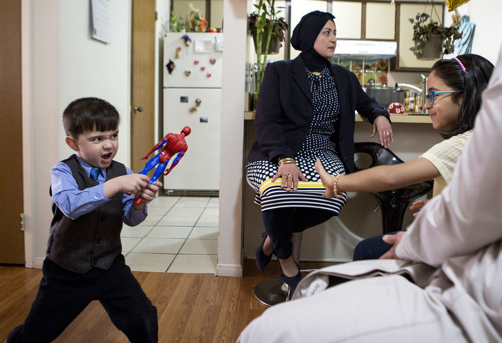 First Place, Photographer of the Year - Small Market - Jessica Phelps / Newark AdvocateMousa playfully attacks his cousin, Ban, with his Spiderman action figure as they wait for more family to arrive for their aunts engagement party, March 25, 2018. Mousa's parents  are making sure he and his sisters experience the best of American culture, while ensuring they hold onto their Iraqi roots. 