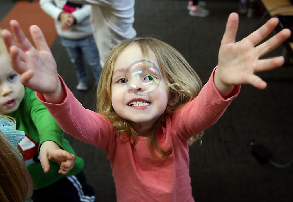 Second Place, Photographer of the Year - Small Market - Lorrie Cecil / ThisWeek NewspapersAlexandria Koebel, two, chases bubbles during the Dance Party at the Orange Branch Library on Monday February 19.   The Dance Party is held every Monday at 10AM and is structured toward toddler and preschool aged children.  