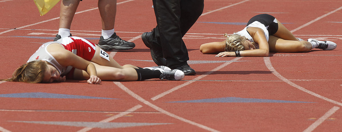 Second Place, Photographer of the Year - Small Market - Lorrie Cecil / ThisWeek NewspapersSheridan'sAnna Foster, left, and Kettering Archbishop Alter's Perri Bockrath collapse on the track after finishing first and second in the Division II girls 3200 meter during the State Track and Field Meet on Saturday June 2 at Jesse Owens Memorial Stadium.  