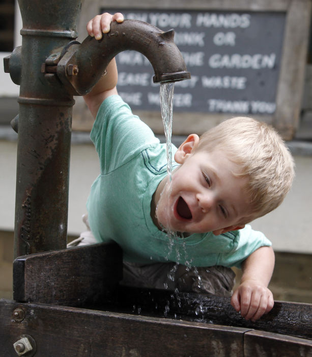 Second Place, Photographer of the Year - Small Market - Lorrie Cecil / ThisWeek Newspapers One year old Graham Prorok of Pickerington gets a drink from the fountain at the Slate Run Living Historical Farm on Friday July 6.  Friday was Story Time at the farm and visitors could listen to "The Little Red Hen" being read.  For a schedule of events at Slate Run Historical Farm and the other Metro Parks visit metroparks.net