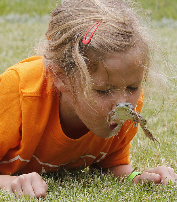 Second Place, Photographer of the Year - Small Market - Lorrie Cecil / ThisWeek NewspapersNora Paxton, six, gets her frog to jump by blowing on him during the Dublin Kiwanis Frog Jump on Saturday June 23 at Coffman Park.  