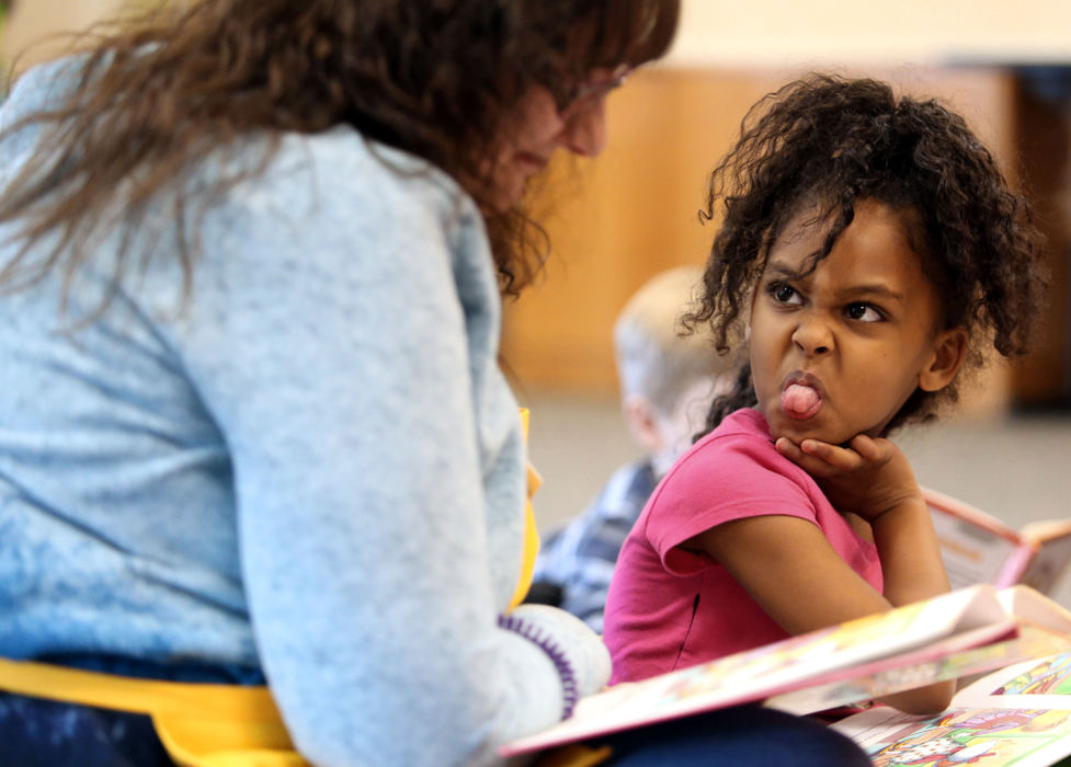 Second Place, Photographer of the Year - Small Market - Lorrie Cecil / ThisWeek NewspapersFour year old Hosana Debessay of Groveport has fun making a funny face at Youth Services Specialist Sheri Nicodemus as they read "Chrysanthemum" during the Reading Buddies Power Hour at the Southeast Branch of the Columbus Metropolitan Library on Wednesday March 7.  During the group program kids 6-11 read together and play literacy games.  