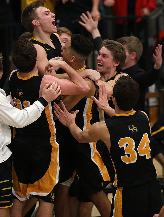 Second Place, Photographer of the Year - Small Market - Lorrie Cecil / ThisWeek NewspapersUpper Arlington's Dane Goodwin, top, is mobbed by his teammates after his shot at the buzzer gave the Golden Bears a 44-41 win over Dublin Coffman on Saturday February 3.  