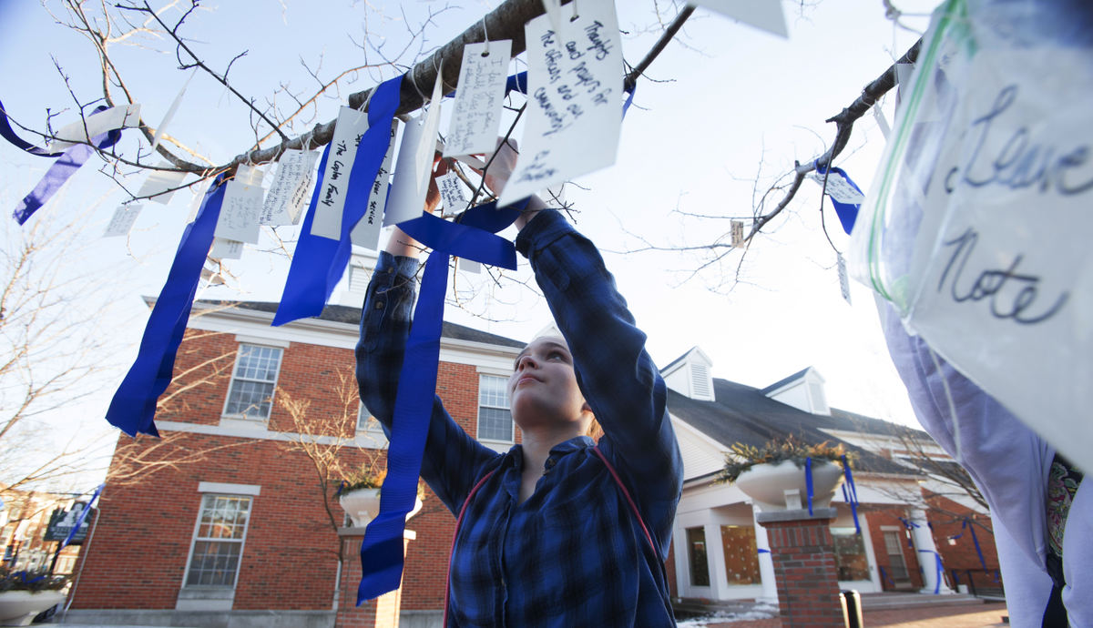 Second Place, Photographer of the Year - Small Market - Lorrie Cecil / ThisWeek NewspapersGrace Fox, 13, and other members of the Generations Performing Arts Center, hang notes of gratitude and condolence Feb. 12 on a tree near the memorial for fallen officers Morelli and Joering.
