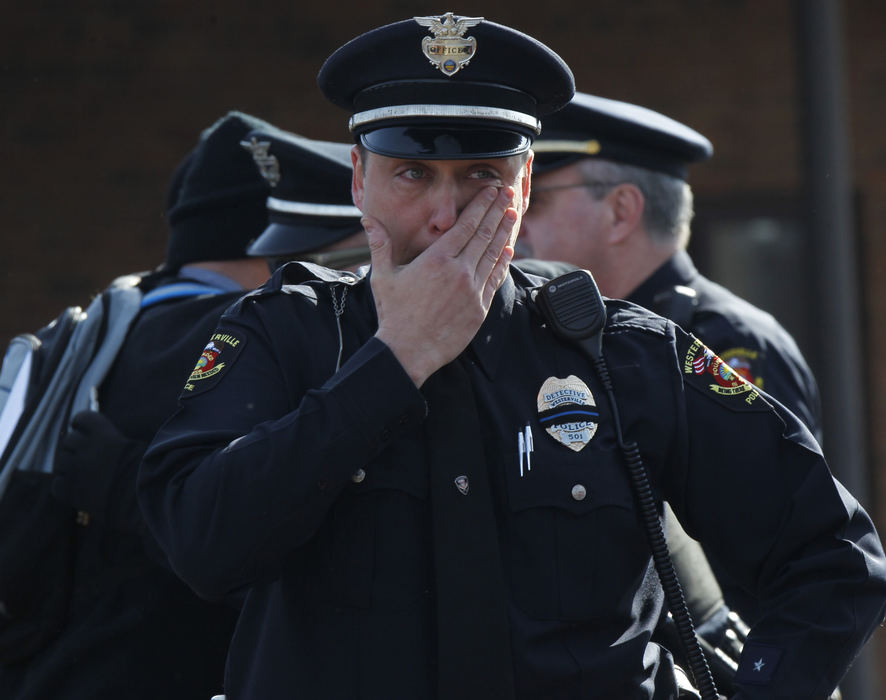 Second Place, Photographer of the Year - Small Market - Lorrie Cecil / ThisWeek NewspapersWesterville Detective Steve Grubbs wipes away tears as he prepares to leave Moreland Funeral Home where the body of Officer Anthony Morelli was escorted.  The escort which included officers from around the state, then escorted the body Officer Eric Joering to Hill Funeral Home.  