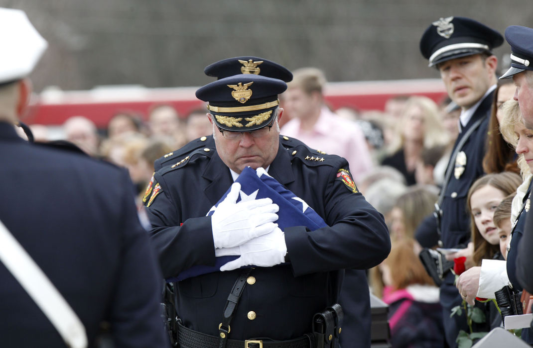 Second Place, Photographer of the Year - Small Market - Lorrie Cecil / ThisWeek NewspapersWesterville Police Chief Joseph Morbitzer carries a folded flag to present to Linda Morelli, the widow of fallen officer Anthony Morelli during a joint funeral for Morelli and fellow Officer Eric Joering  on Friday February 16.   