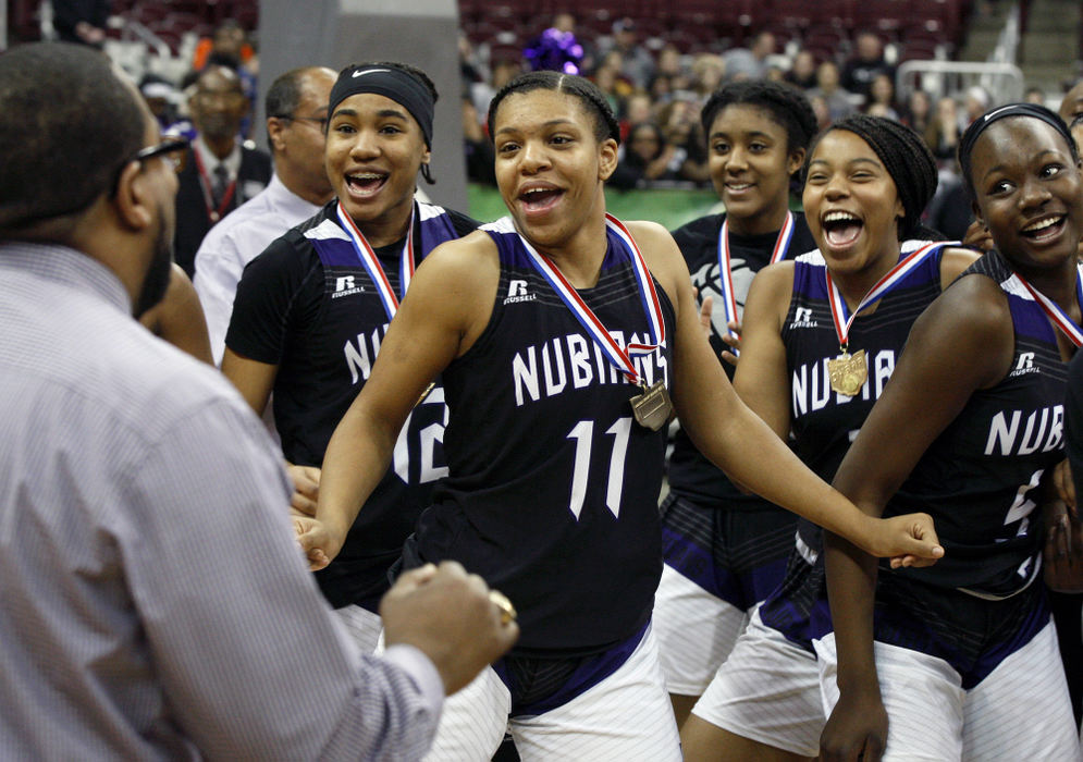 , Photographer of the Year - Small Market - Shane Flanigan / ThisWeek NewspapersAfricentric's Tearra Cook (11), Charjae' Brock (12), Lyric Ransom (3), and Arianna Smith (5), dance with head coach William McKinney as he receives his medal after the Nubians defeated Versailles, 53-47, in the Division III state championship game March 17, 2018, at The Jerome Schottenstein Center in Columbus, Ohio. Africentric claimed its sixth girls basketball title with the victory.