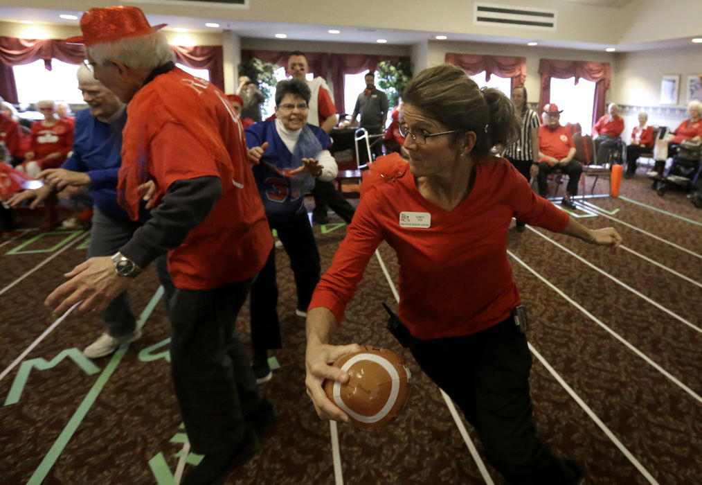 , Photographer of the Year - Small Market - Shane Flanigan / ThisWeek NewspapersKandy Cox, director of resident services and Village 99-ers head coach, runs around her blockers during the Village Super Bowl on Feb 2. 2018, at Willow Brook Christian Village in Delaware, Ohio. 