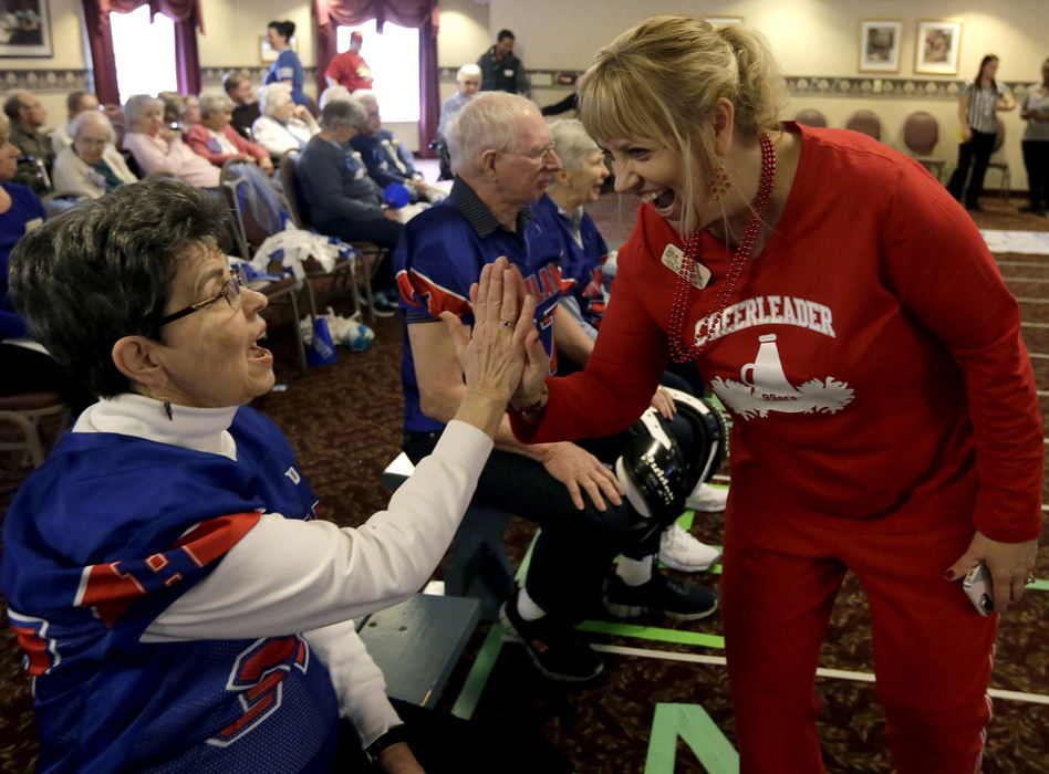 , Photographer of the Year - Small Market - Shane Flanigan / ThisWeek NewspapersJulie Bardelang-Wolf, right, high fives and wishes good luck to Charlene Blum, 76, before the start of the Village Super Bowl on Feb 2. 2018, at Willow Brook Christian Village in Delaware, Ohio. 