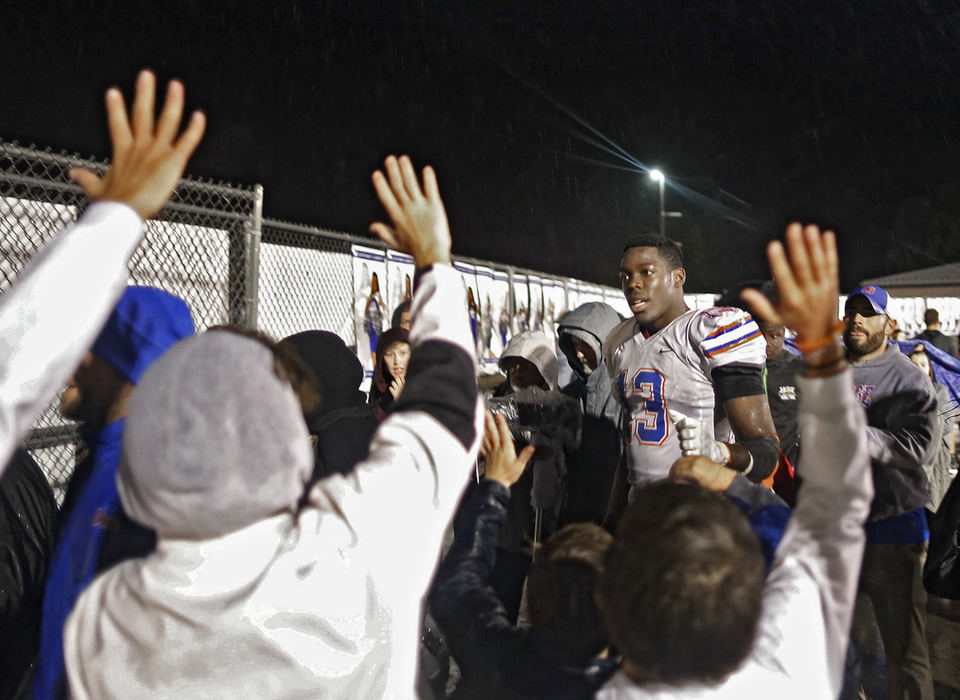 Second Place, Sports Picture Story - Kyle Robertson / The Columbus Dispatch, "Zach Harrison"Olentangy Orange's Zach Harrison high-fives fans after beating cross town rival Olentangy Liberty 17-3 on October 19, 2018. 
