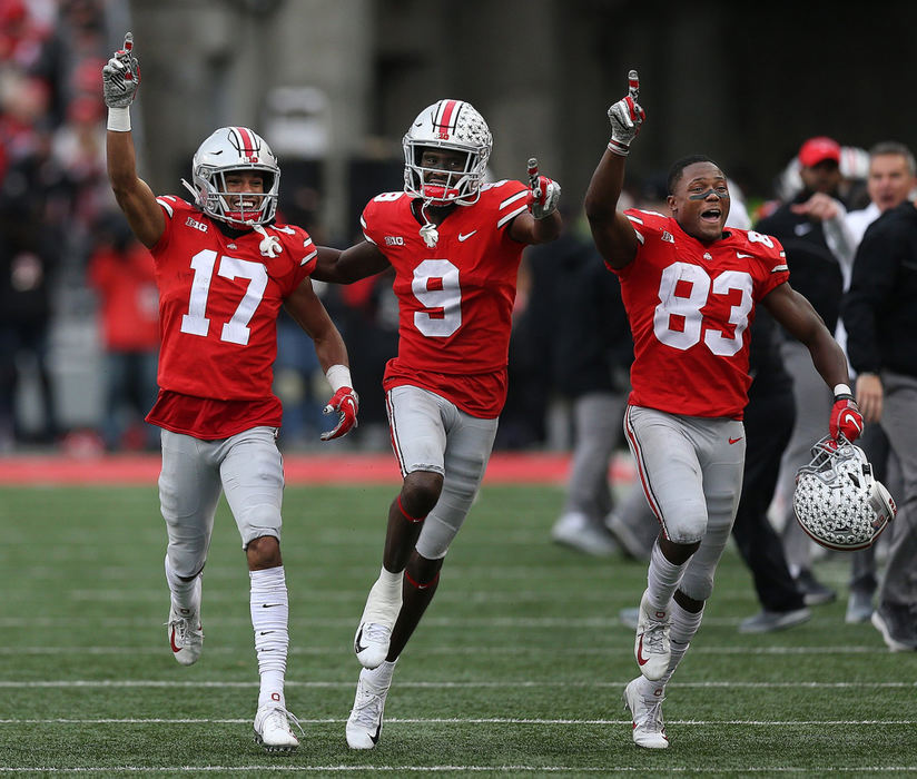 First Place, Team Picture Story - Jonathan Quilter / The Columbus Dispatch, "Ohio State vs. Michigan"Ohio State wide receiver Chris Olave (17) celebrates after blocking a punt that led to a touchdown with wide receivers Binjimen Victor (9) and Terry McLaurin (83) during the second half against Michigan at Ohio Stadium on November 24, 2018.