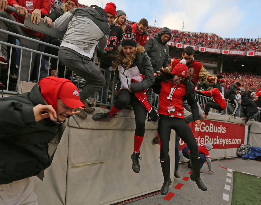 First Place, Team Picture Story - Jonathan Quilter / The Columbus Dispatch, "Ohio State vs. Michigan"Fans jump on to the field following Ohio State's 62-39 victory over Michigan at Ohio Stadium on November 24, 2018. 