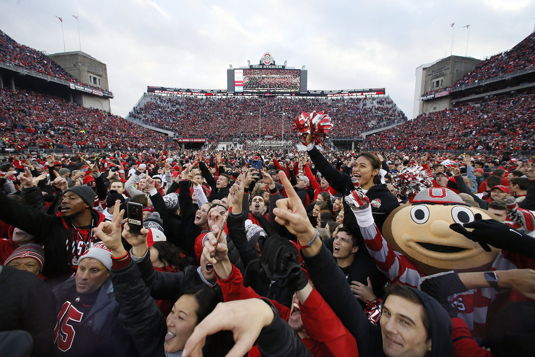 First Place, Team Picture Story - Adam Cairns / The Columbus Dispatch, "Ohio State vs. Michigan"Brutus Buckeye and fellow Ohio State Buckeyes fans rush the field following their game against Michigan at Ohio Stadium in Columbus on Nov. 24, 2018. Ohio State won 62-39. 
