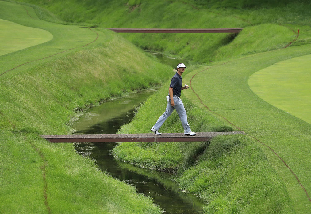 Second Place, Team Picture Story - Adam Cairns / The Columbus Dispatch, "The Memorial"Beau Hossler walks across the bridge on the 11th hole during the second round of the Memorial Tournament at Muirfield Village Golf Club in Dublin, Ohio on May 31, 2018.