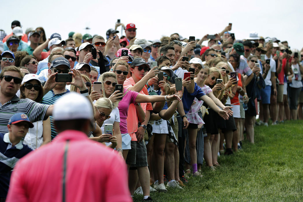 Second Place, Team Picture Story - Kyle Robertson / The Columbus Dispatch, "The Memorial"Patrons take a pictures of Tiger Woods as he walks to the 10th tee during the 3rd round of the Memorial Tournament at Muirfield Village Golf Club in Dublin, Ohio on June 2, 2018. 