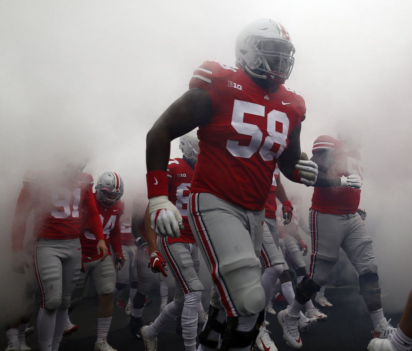 First Place, Team Picture Story - Adam Cairns / The Columbus Dispatch, "Ohio State vs. Michigan"Ohio State offensive lineman Joshua Alabi (58) takes the field prior to the game against the Michigan at Ohio Stadium in Columbus on Nov. 24, 2018.