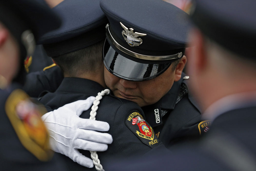 , Team Picture Story - Kyle Robertson / Dsipatch Media Group, "Westerville Strong"Westerville Honor Guard members embrace after funeral services for fallen officers Joering and Morelli at St. Paul Catholic Church in Westerville on February 16, 2018.  