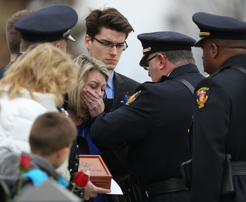 , Team Picture Story - Jonathan Quilter / Dsipatch Media Group, "Westerville Strong"Linda Morelli cries as she is presented with the flag from Westerville Police Chief Joseph Morbitzer following the funeral service for Westerville police officers Eric Joering and her husband Anthony Morelli at St. Paul the Apostle Catholic church in Westerville on February 16, 2018.  