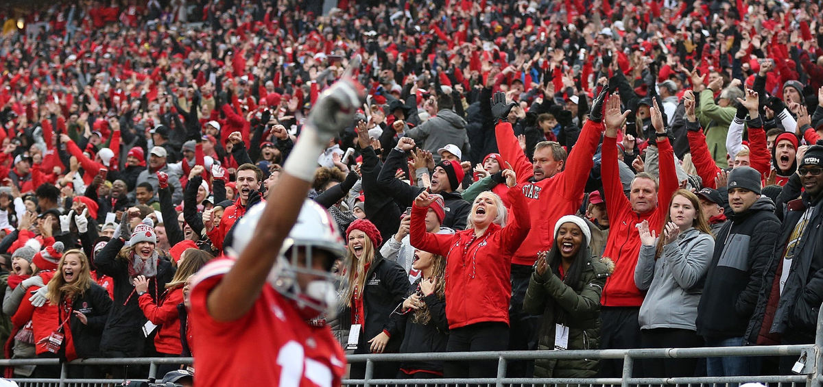 First Place, Team Picture Story - Jonathan Quilter / The Columbus Dispatch, "Ohio State vs. Michigan"Fans celebrate after Ohio State wide receiver Chris Olave (17) scores a touchdown during the first half against Michigan at Ohio Stadium on November 24, 2018. 